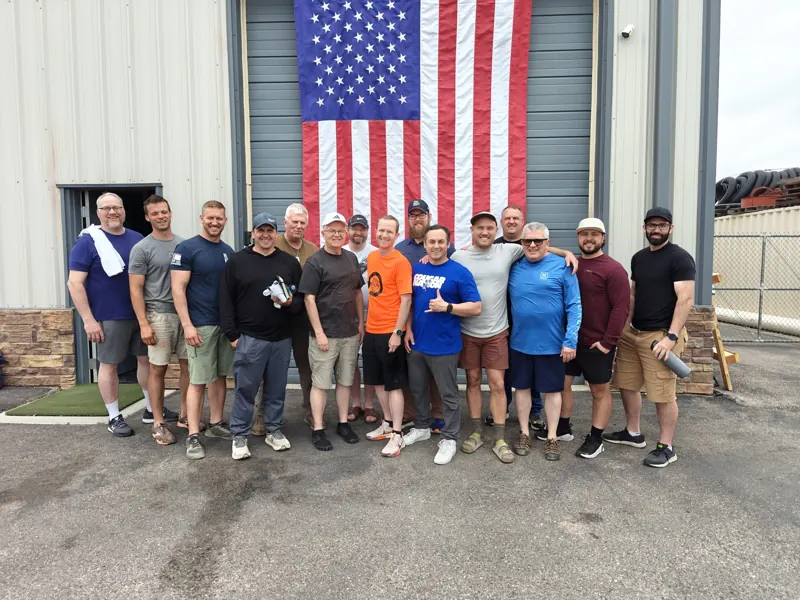 FSD members standing together in front of an American flag